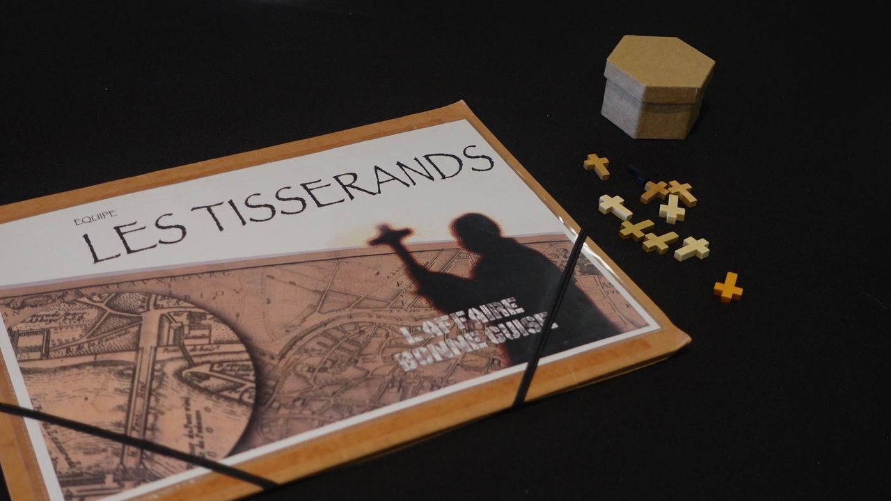 Dossier d'équipe « Les Tisserands » et pions de jeu en bois de la murder party L'affaire Bonne Guise, au Mas Tolosa